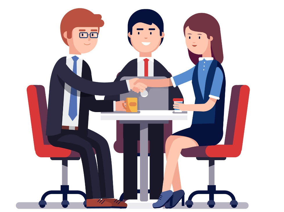 3 people smiling at a table, with 2 shaking hands