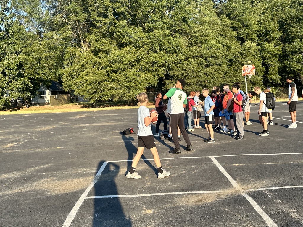 athletes playing football with the students