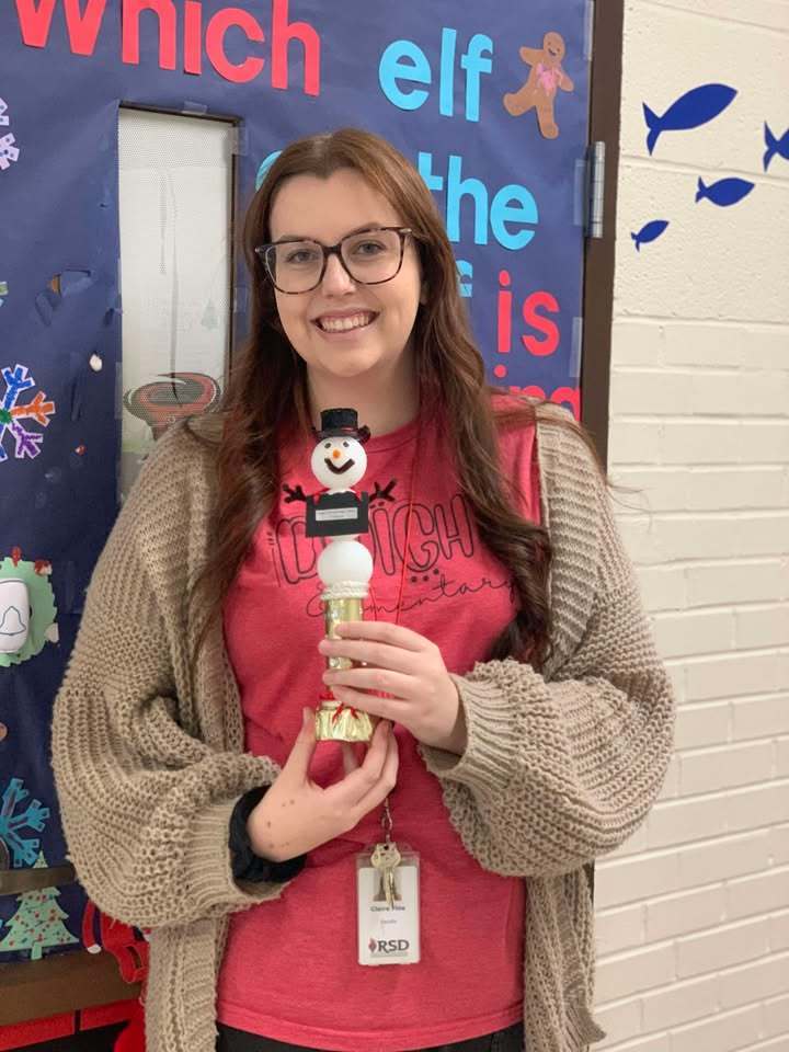 Lady holding a snowman trophy 
