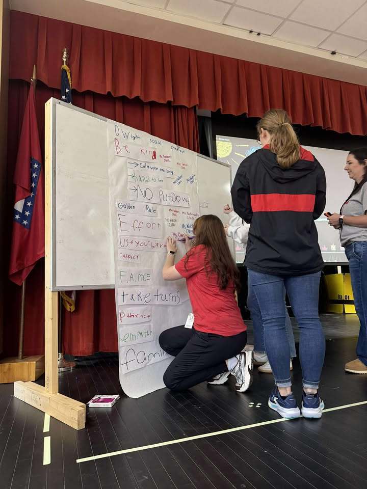 People signing a paper