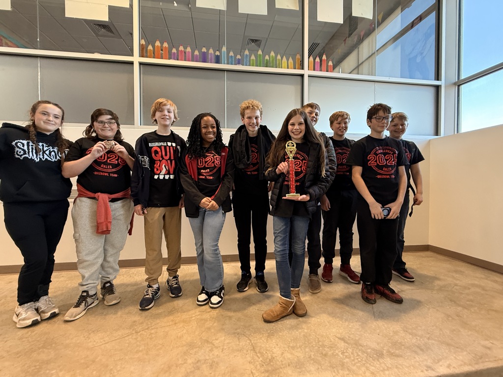7th grade quiz bowl students with their trophy