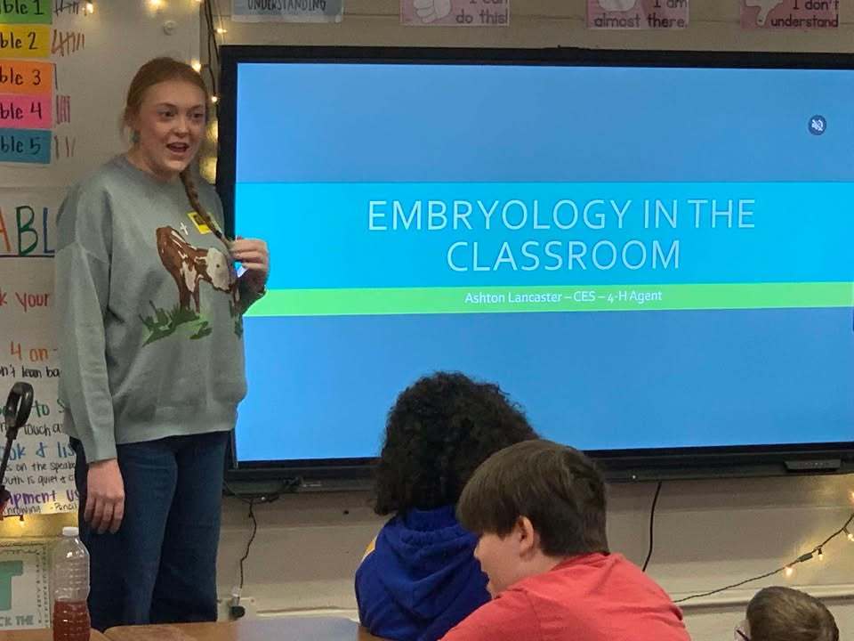 Ashton Lancaster, 4_H Agent, speaks to the class about egg development