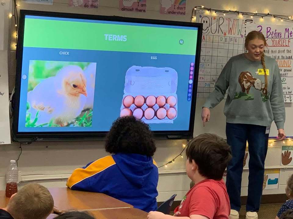 Ashton Lancaster, 4_H Agent, speaks to the class about egg development