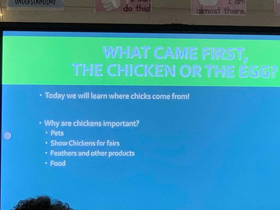 Ashton Lancaster, 4_H Agent, speaks to the class about egg development
