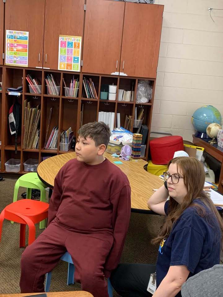 Ashton Lancaster, 4_H Agent, speaks to the class about egg development