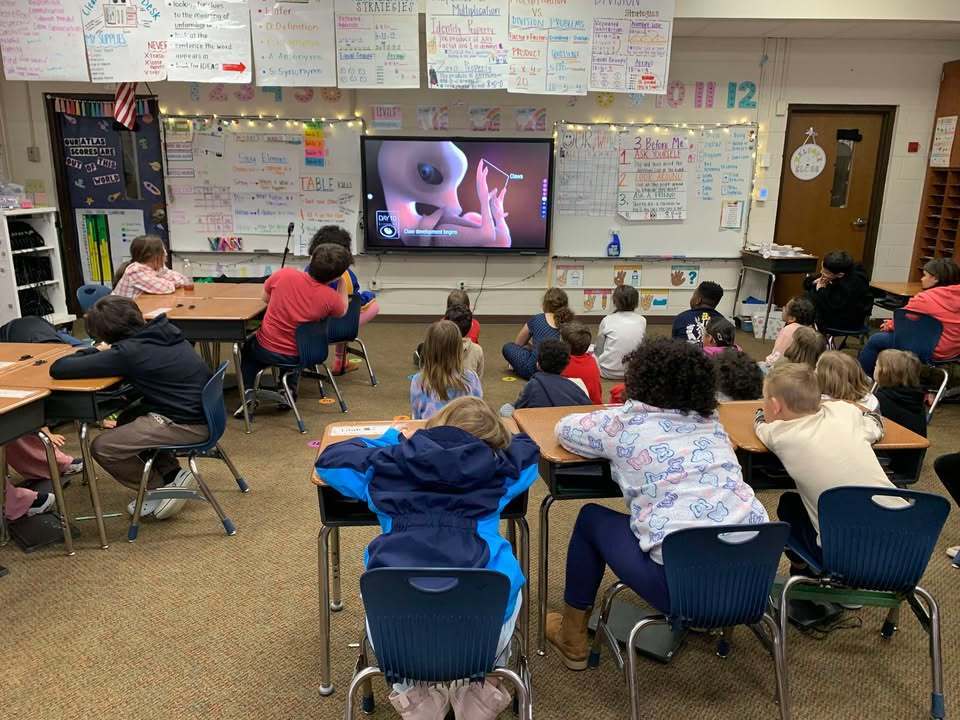 Ashton Lancaster, 4_H Agent, speaks to the class about egg development