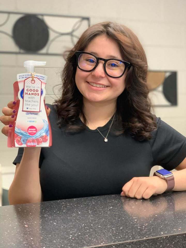 Teacher holding handsoap