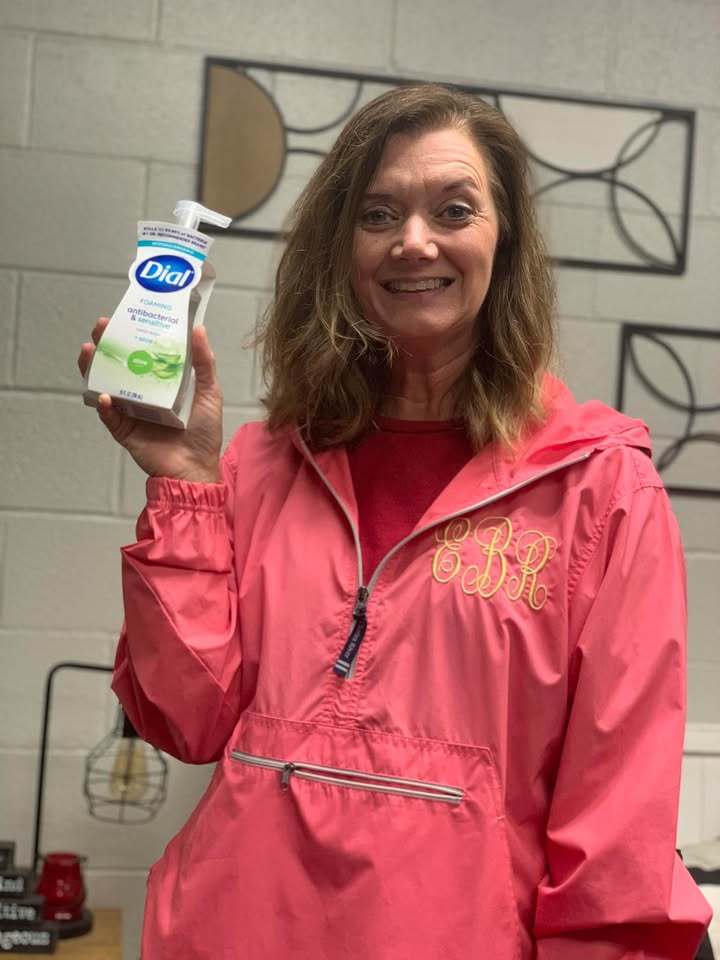 Teacher holding handsoap