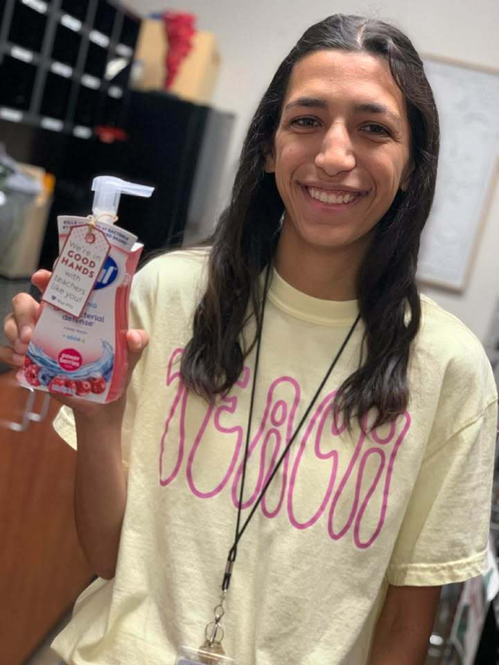 Teacher holding handsoap