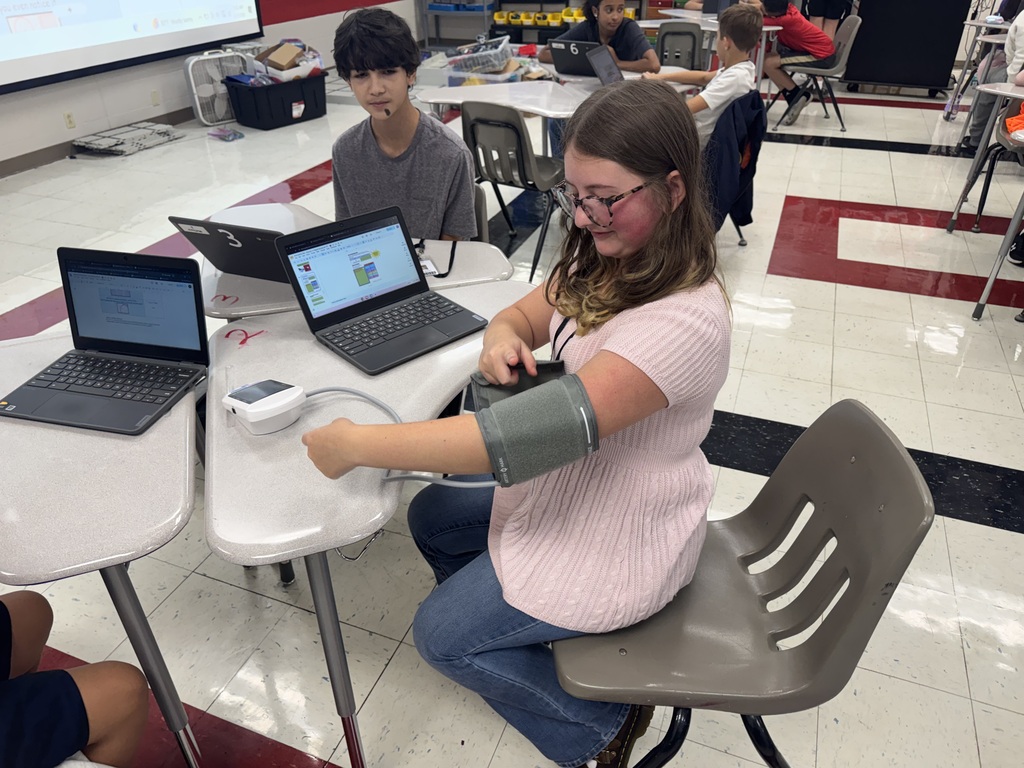 a student putting on a blood pressure cuff