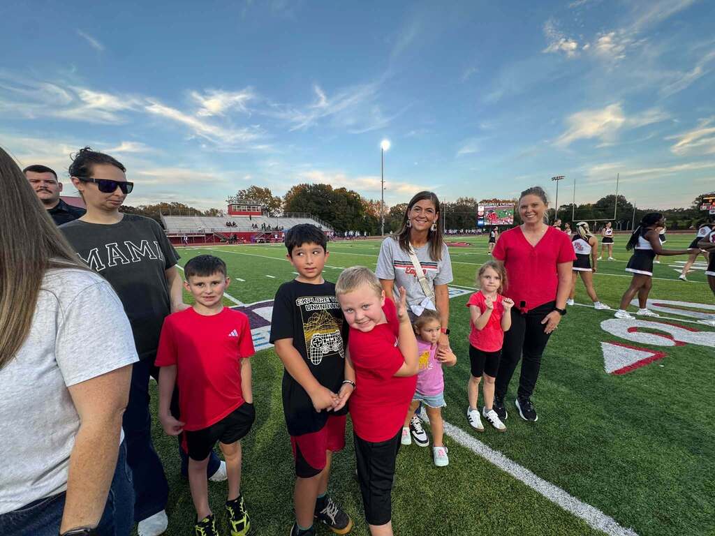 group of people standing on a football field
