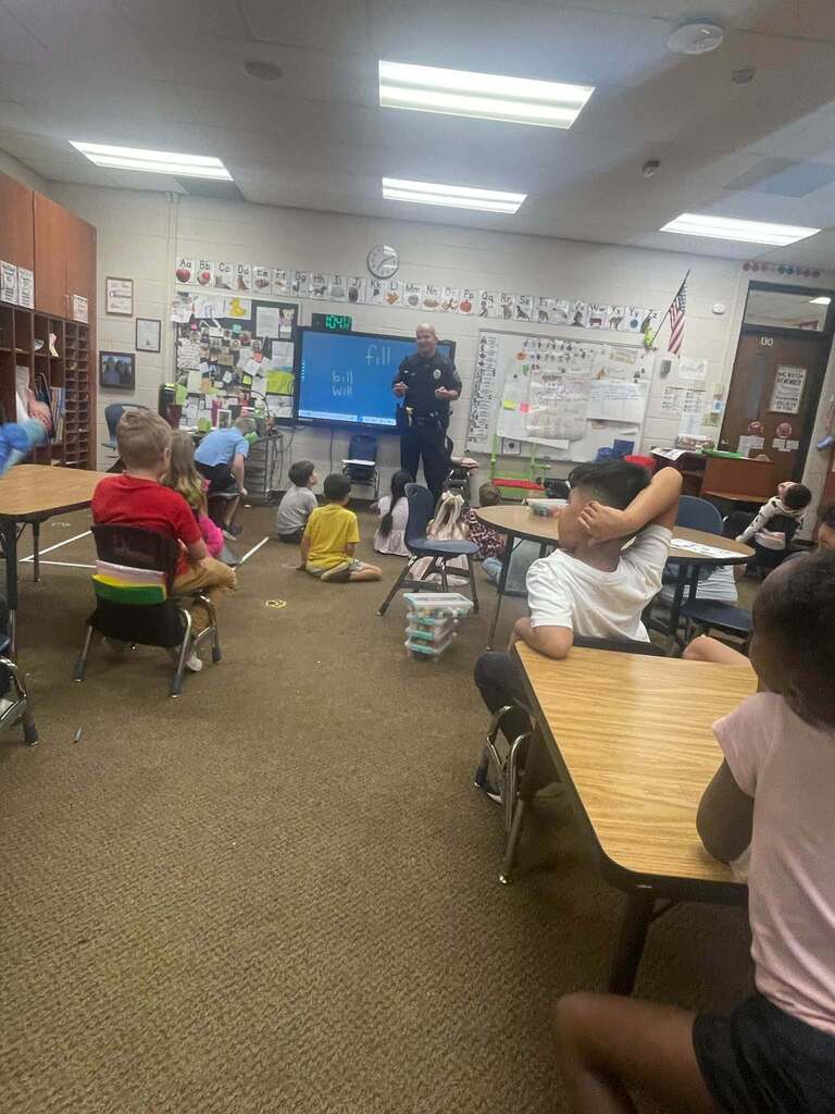 man standing at the front of a classroom