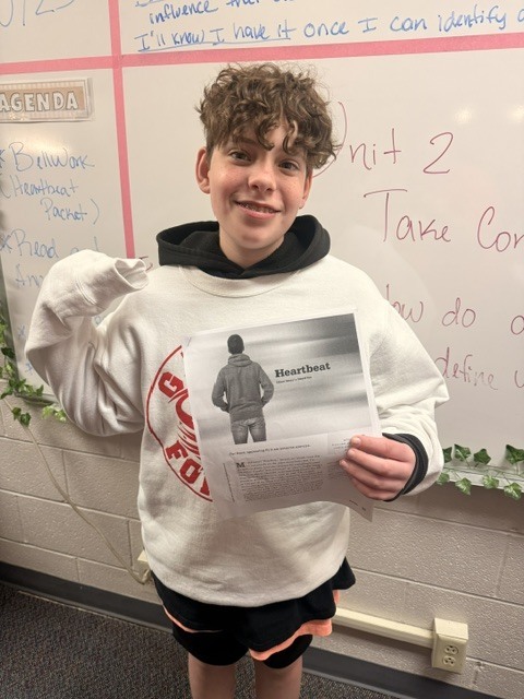 student holding up the script