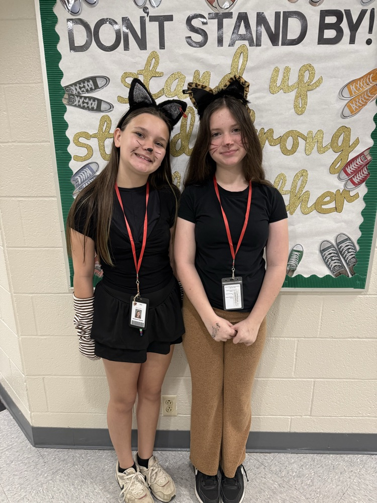 girls dressed up as cats together