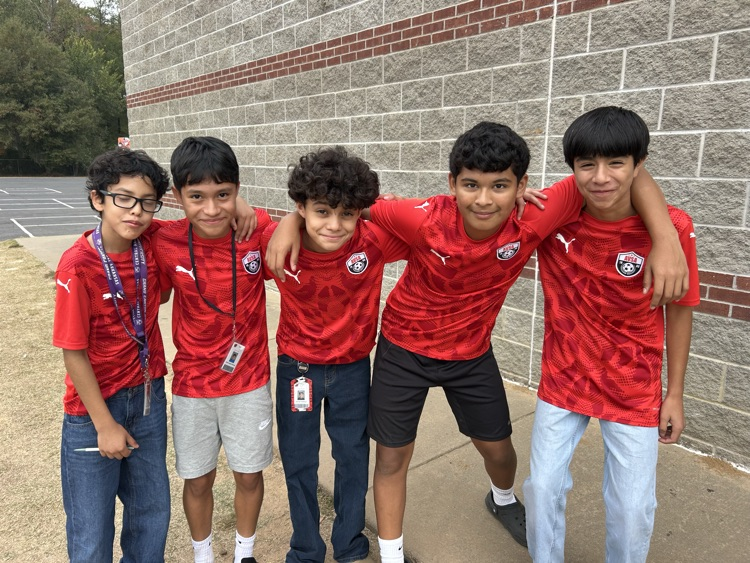 a group of boys wearing soccer shirts