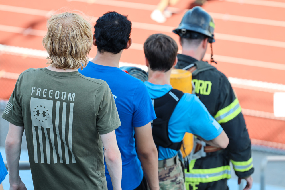 Students and fireman climbing down stairs