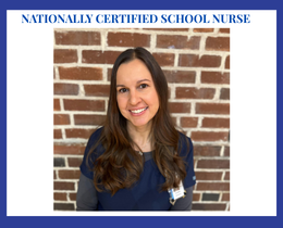 A woman with long brown hair smiles at the camera. She wears a blue scrub top. Behind her, a brick wall.