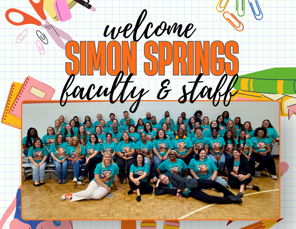 Faculty and staff at Simon Springs pose for a photo. They wear teal shirts and sit on the floor in a gymnasium.