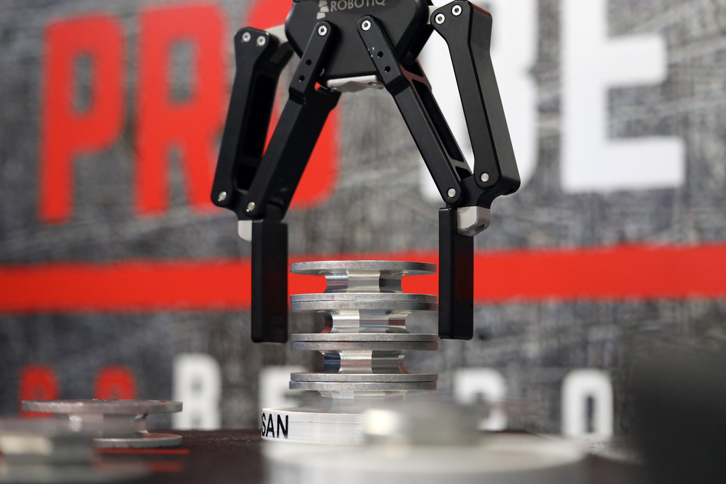 Robotic arm places dies in stack.