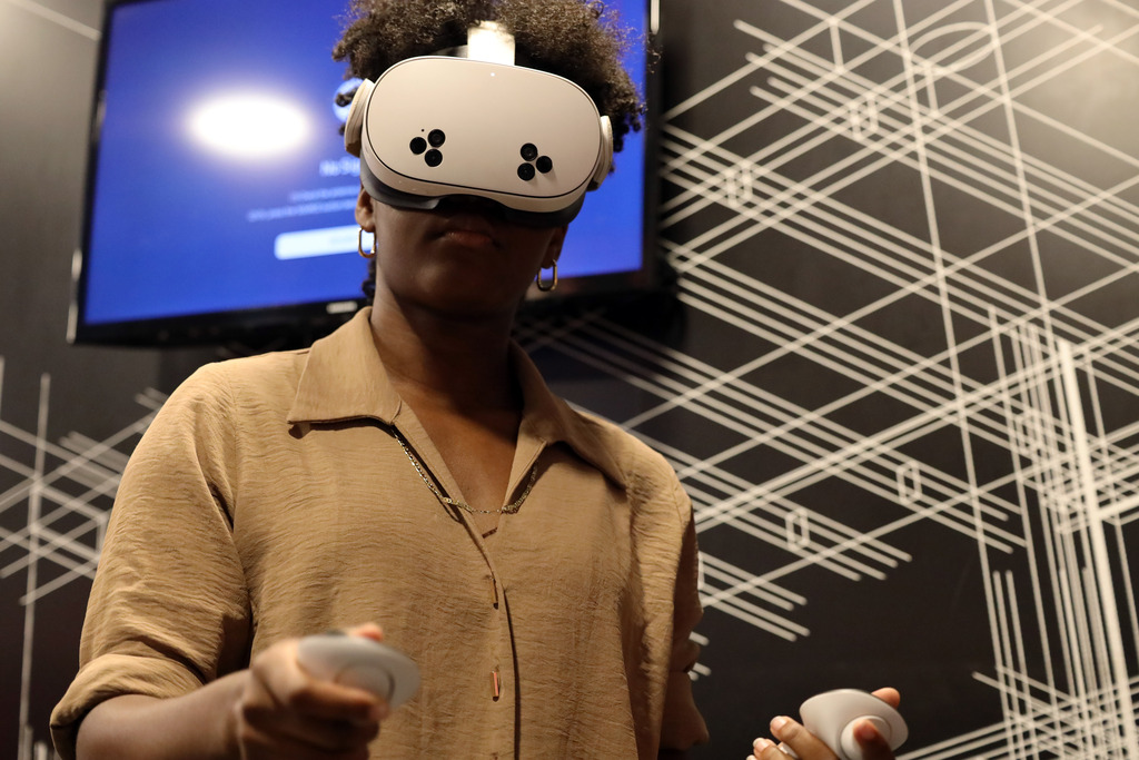 Student operates VR headset and controller.