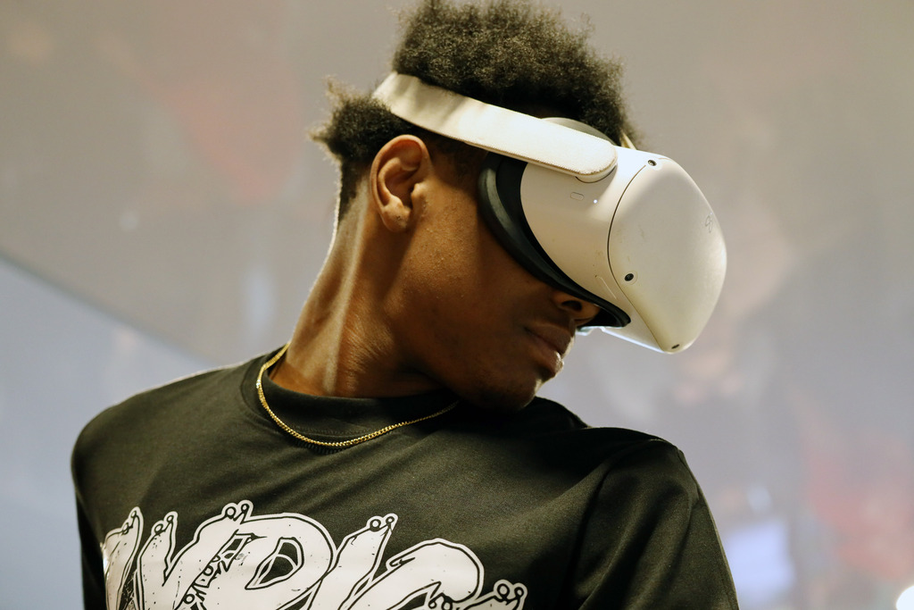 Male student in black shirt operates VR headset