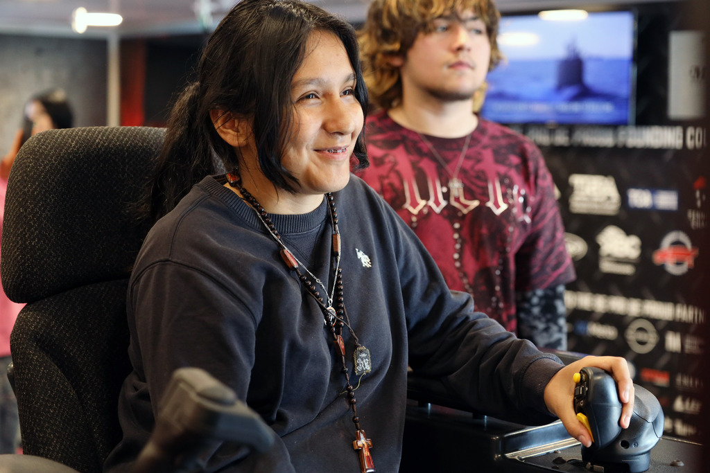 Female student drives simulator.