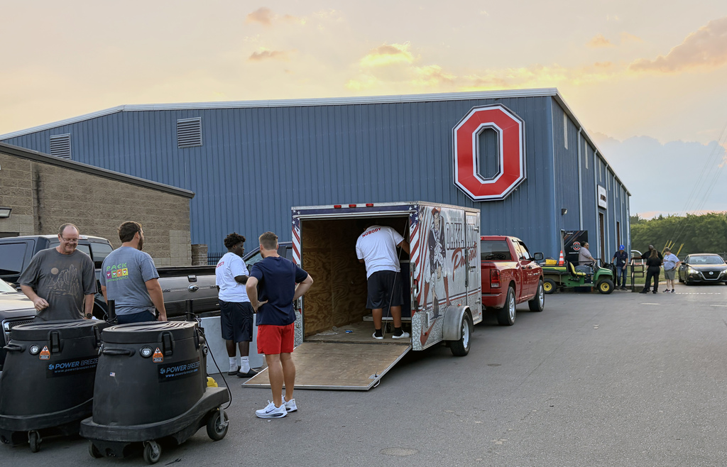 Football equipment being loaded onto a trailer at Oakland High School