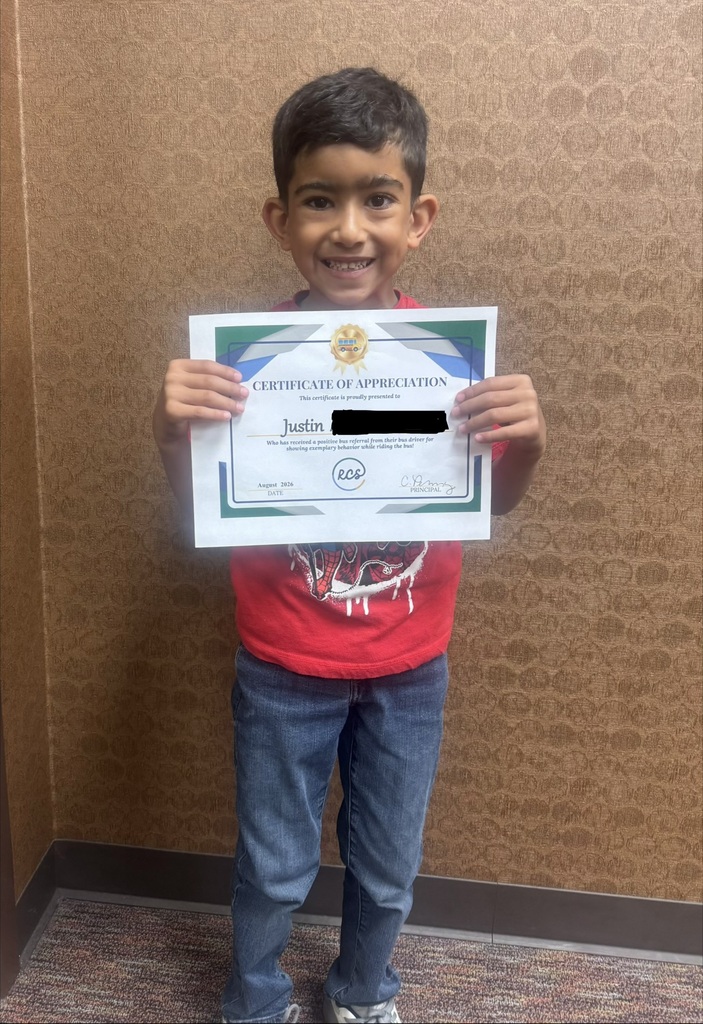 Student holding a positive bus referral