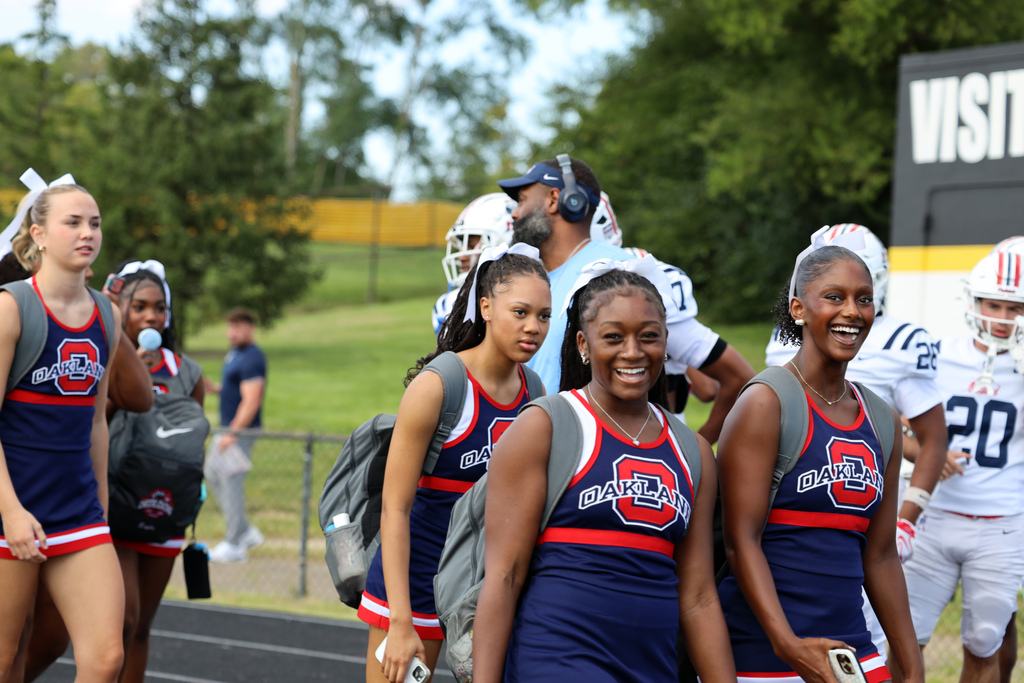 cheerleaders smile as entering stadium