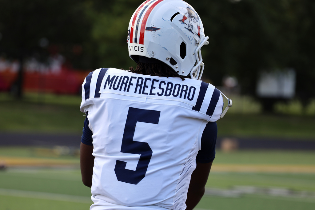 football player in white with murfreesboro across upper back
