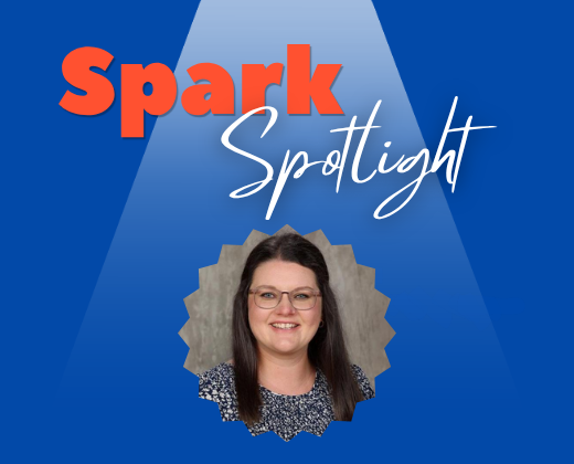 Woman with glasses smiling, framed by a spotlight, on a blue background. Text reads "Spark Spotlight" above her.