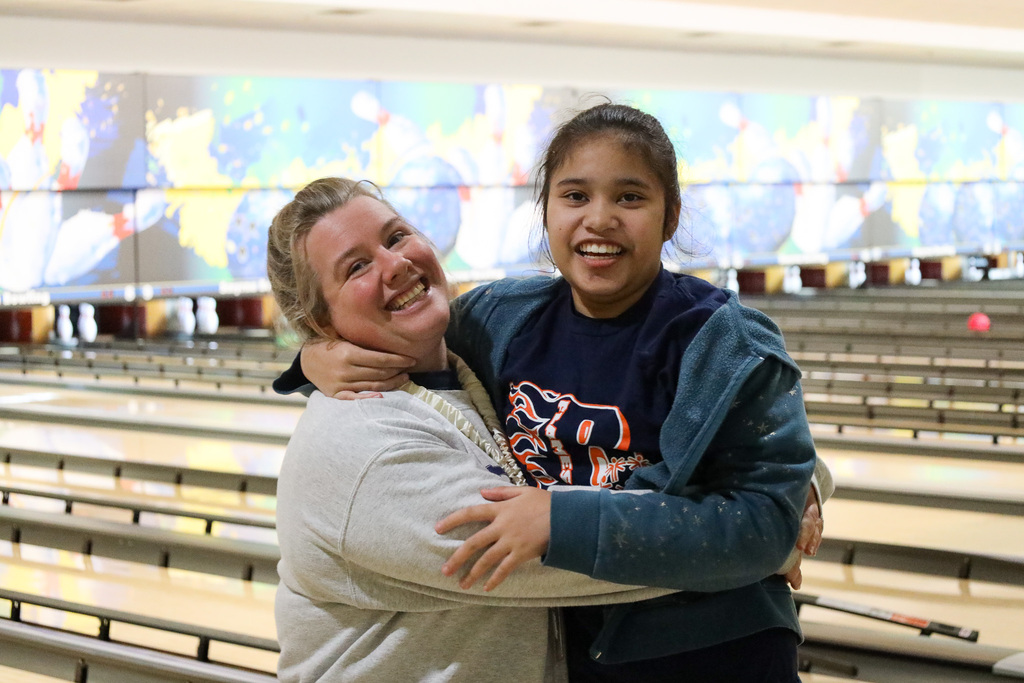 Staff member and student smiling for camera
