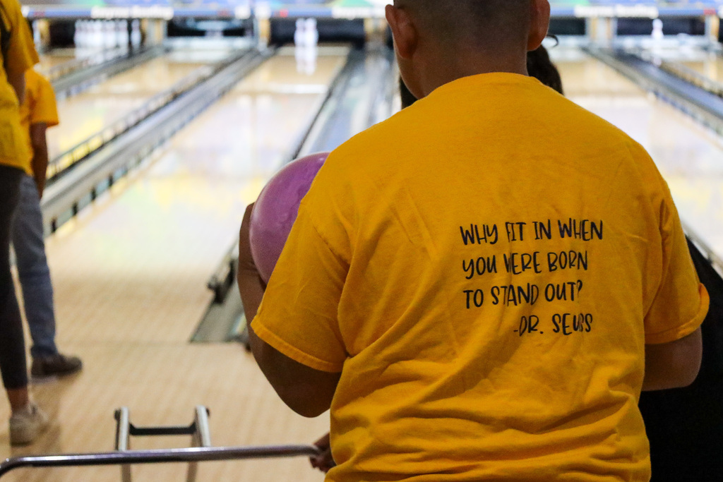 The back of a student's shirt that reads, "Why fit in when you were born to stand out?"- Dr. Seuss