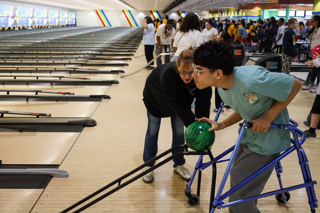 Staff member helping student bowl