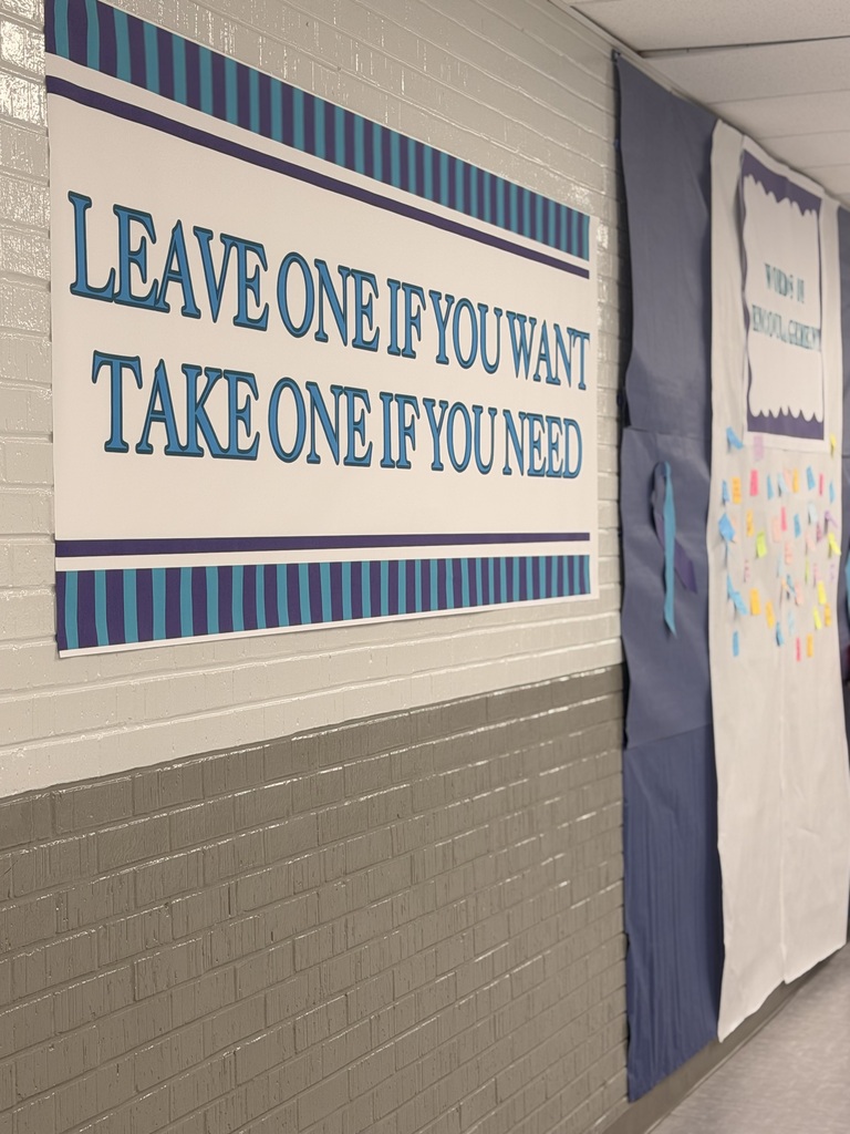 A hallway displays a banner with blue and white stripes reading "LEAVE ONE IF YOU WANT TAKE ONE IF YOU NEED."
