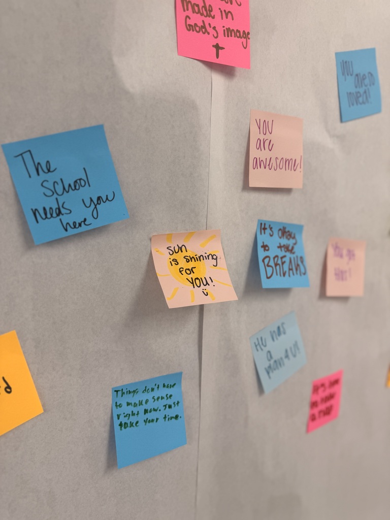 A white board with multiple sticky notes attached, each containing messages like "The School needs you here," "You are awesome," and "sun is shining for you."