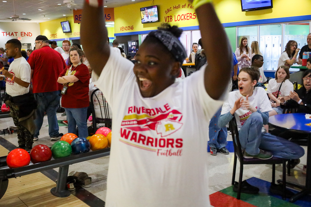 Student with her hands in the air cheering