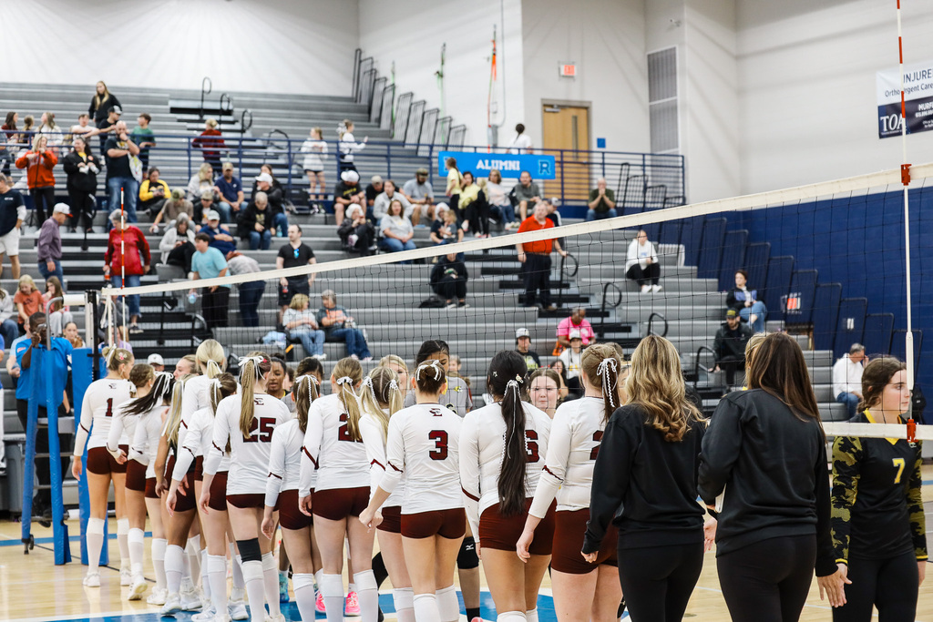 Volleball team high fiving other team