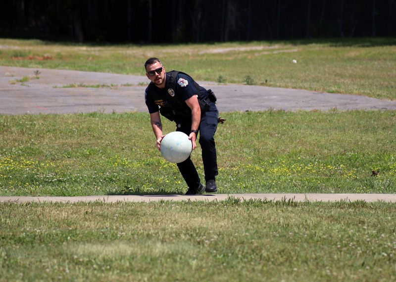 police officer throws ball diring kickball game