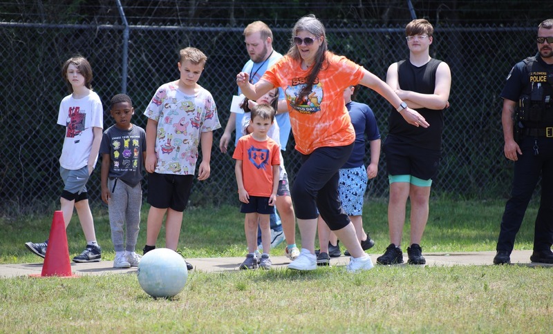 teacher prepares to kick during kickball game