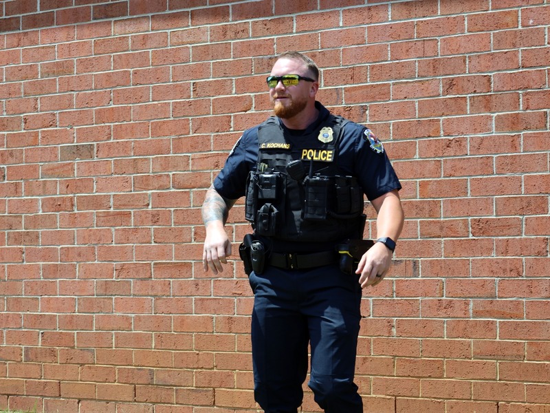 police officer watches kickball game