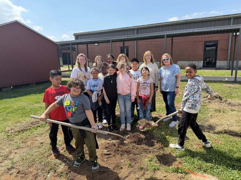 Group of students with shovels