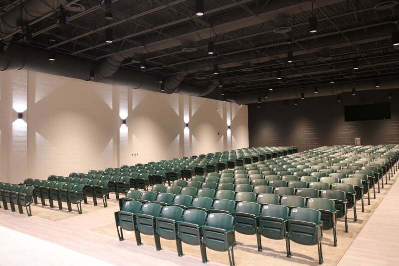 Green chairs inside Poplar Hill Middle theater