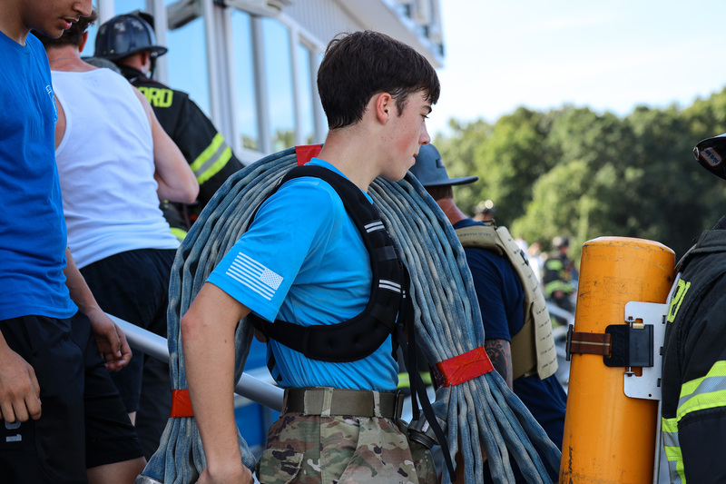 Students and fireman climbing stadium stairs
