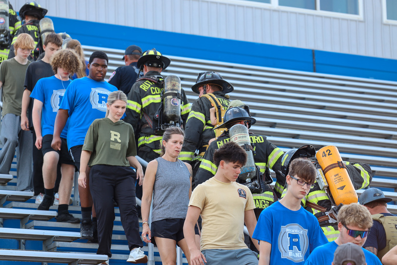 Principal Turnbow, students, and firefighters climbing stairs
