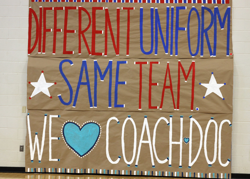 poster says different uniform, same team. we love coach doc