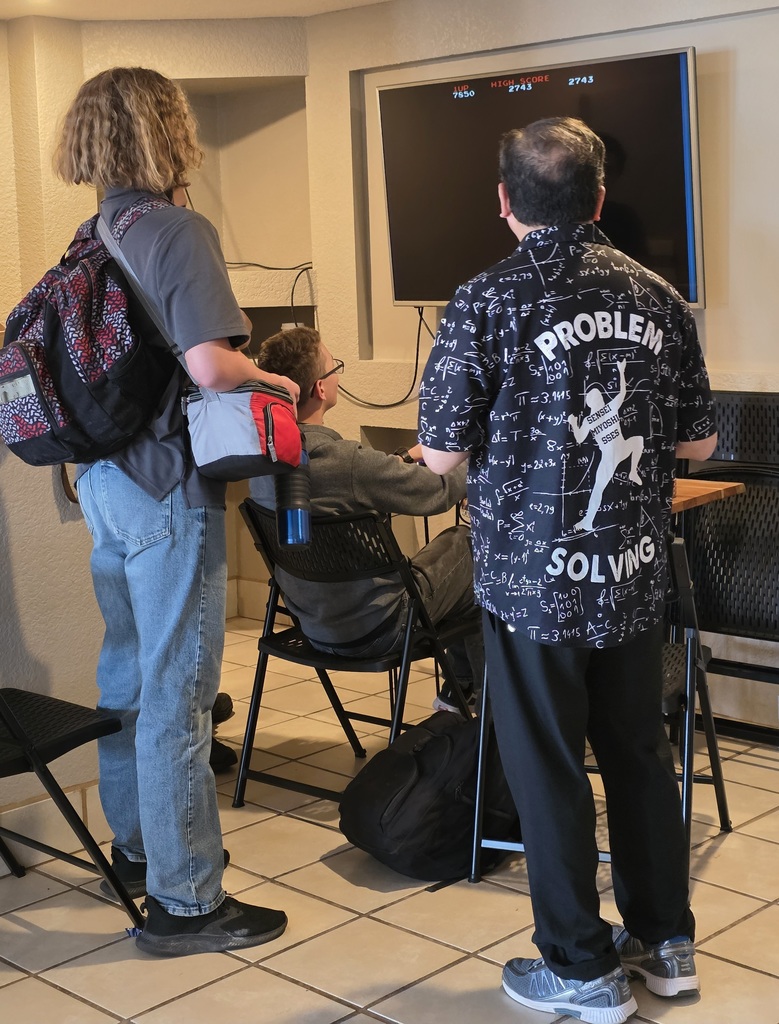 Students and teacher playing video game