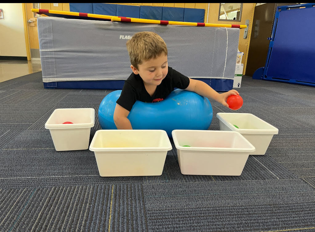 Student work on gross motor skills. (Crossing Middle Line)