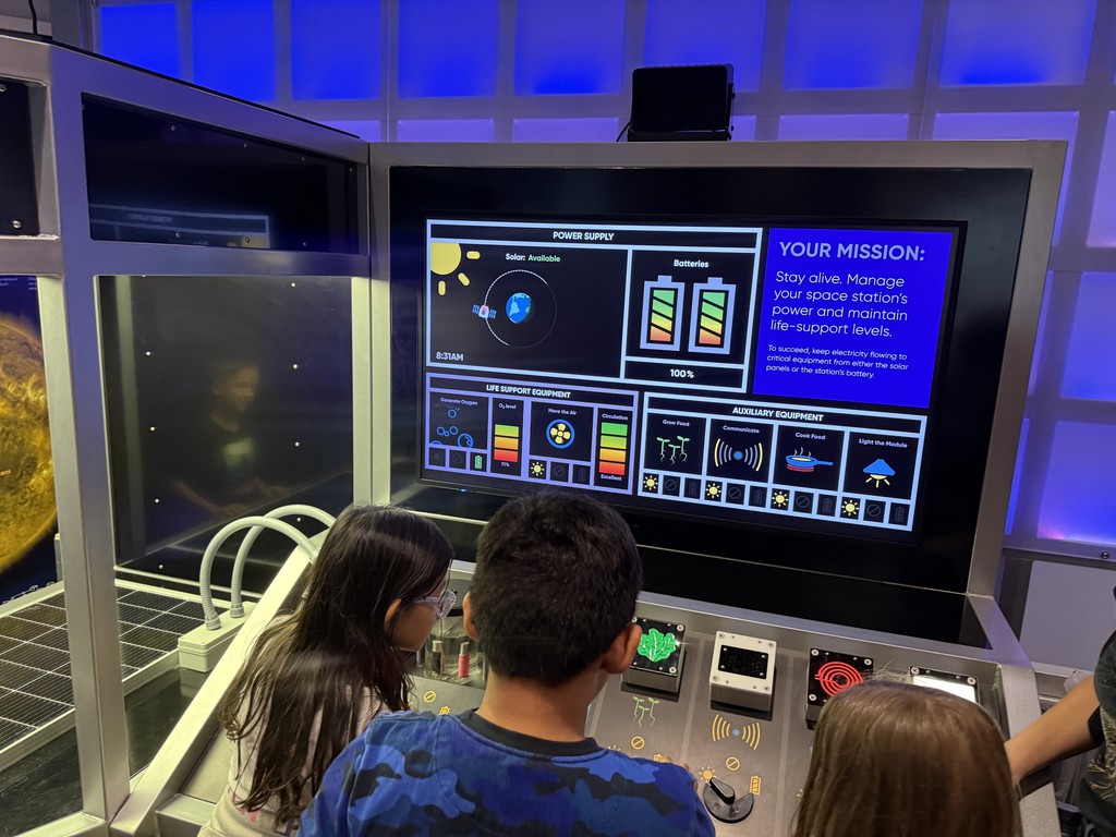 Students playing a space station game
