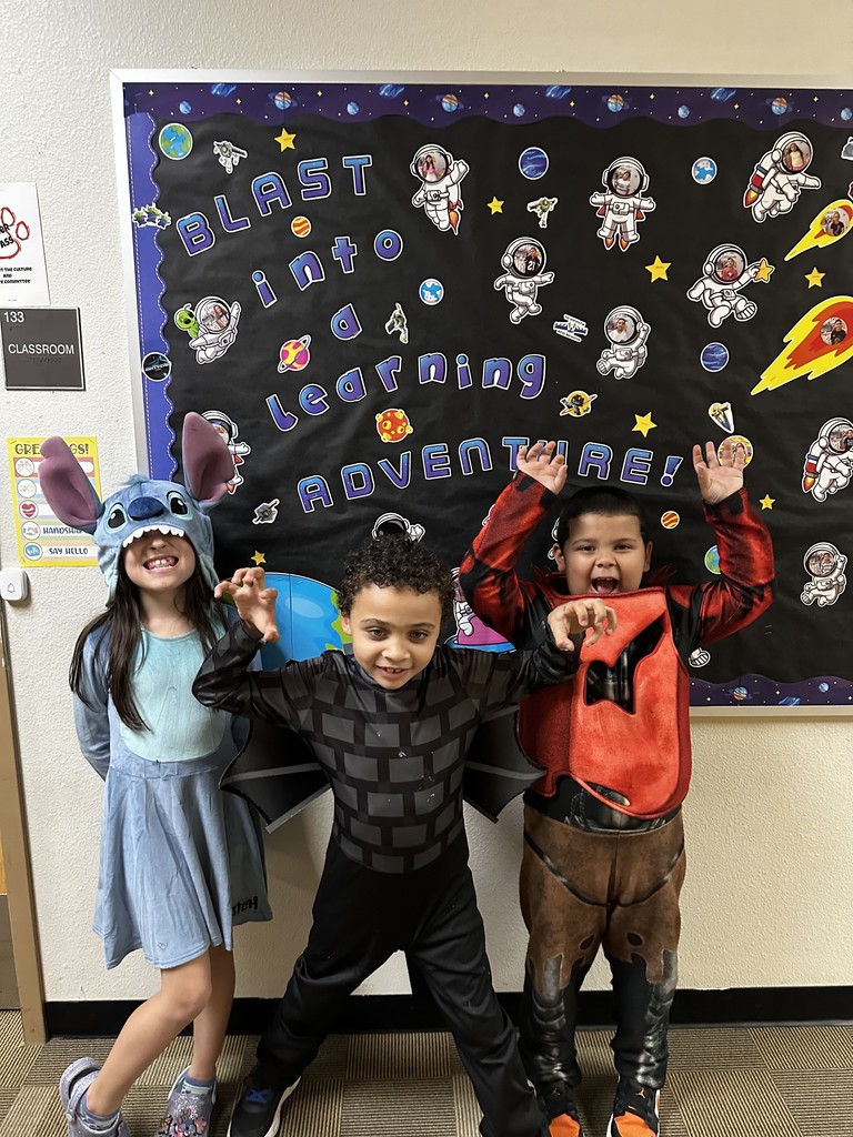 3 students posing in  their costumes